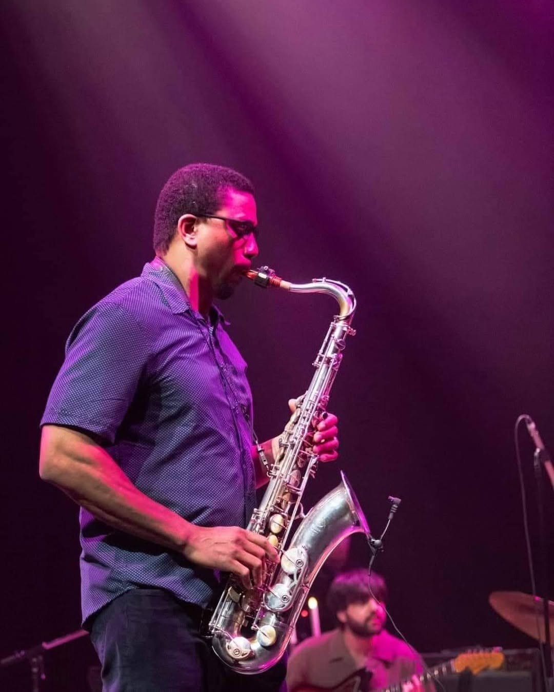 Carlos playing sax on stage