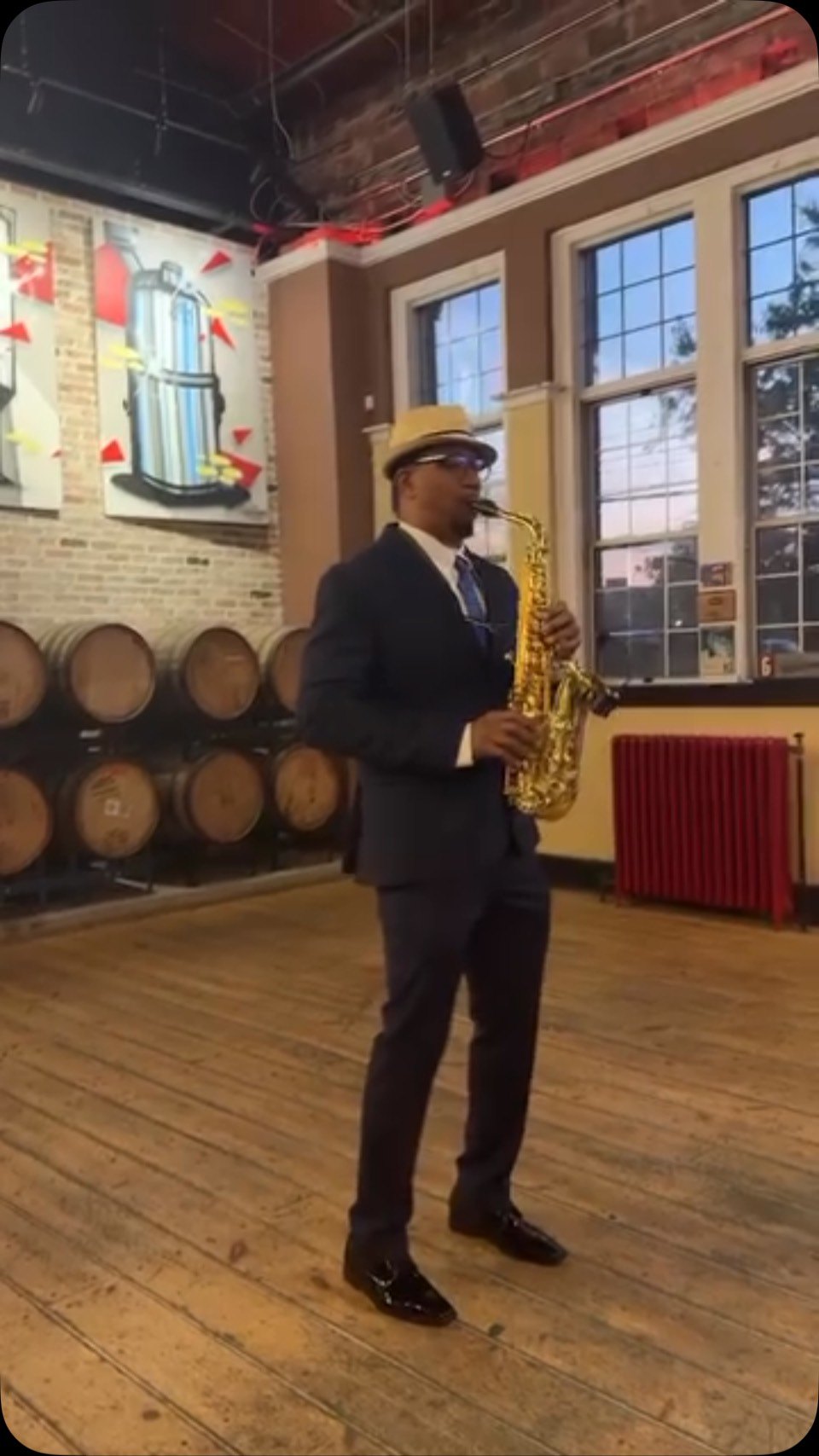 Carlos playing sax at an event venue