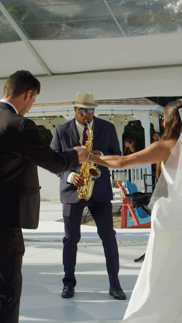 Carlos playing sax for a couple's wedding entrance